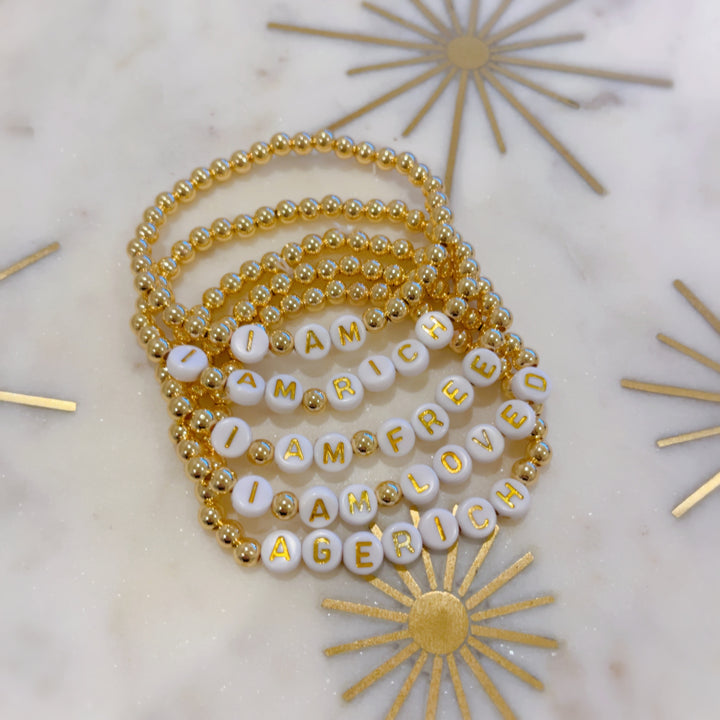 Affirmation Bracelet Set: In our 'Affirmation Bracelet Set' 14k gold plated beads, you'll have all of our 4 key affirmations including our limited AGERICH bracelet.  'I AM' 'I AM RICH' 'I AM LOVED' 'I AM FREE' 'AGERICH'